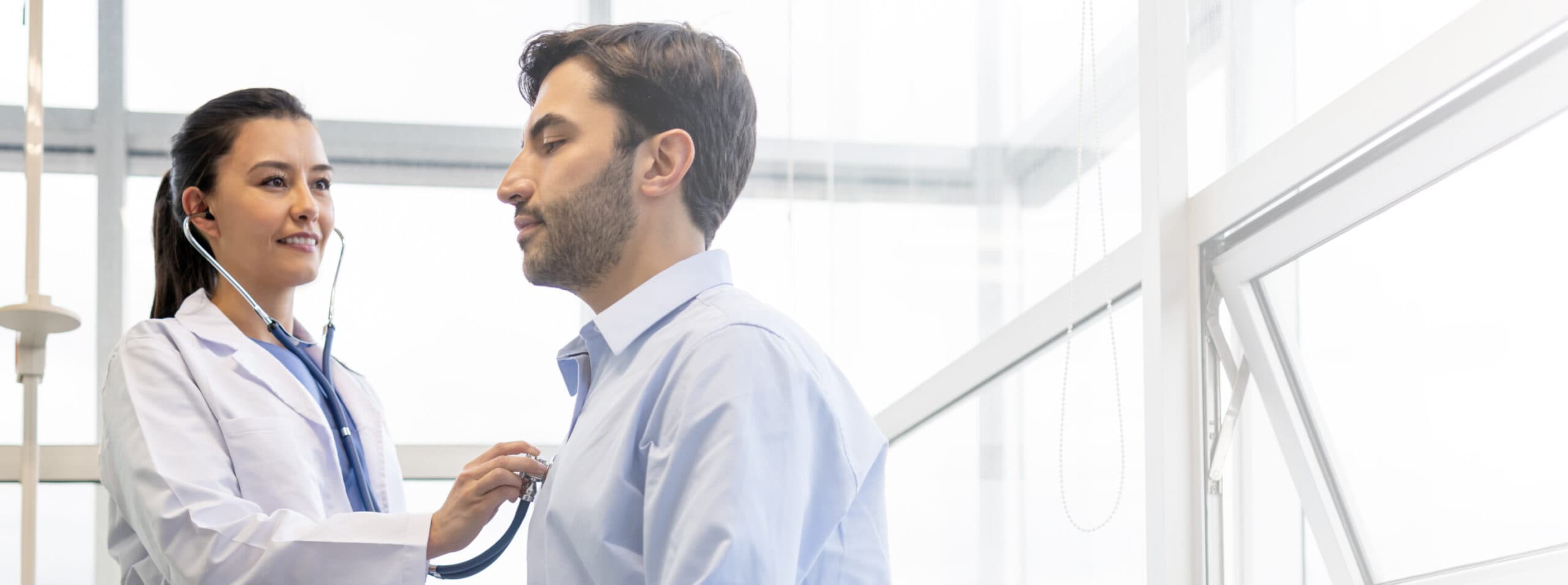 Photo of a doctor examining a patient using a stethoscope