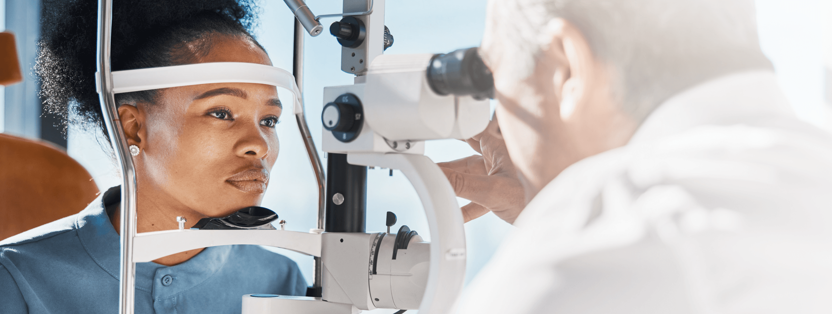 Photo of an ophthalmologist examining the eye of a patient